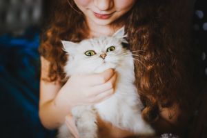 young girl with cat - responsible pet owner